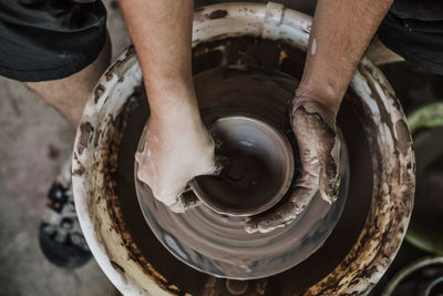 Close-up of artist making pot at workshop