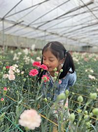 Young woman blowing flowers