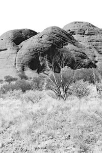 Rocks on field against clear sky