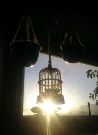 Low angle view of illuminated lantern hanging against sky