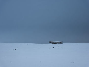 Scenic view of snow against clear blue sky during winter