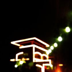 Low angle view of illuminated lights at night