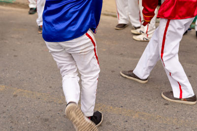 Low view of members of a marujada performing through the streets of the city of saubara,