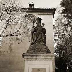 Low angle view of statue against trees