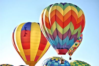 Low angle view of colorful parachutes