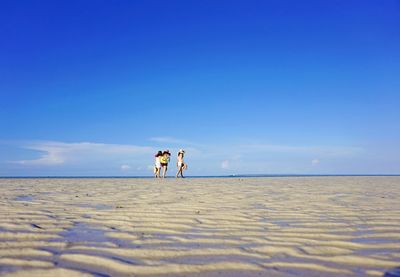 Beautiful women having fun on beach during sunny day 