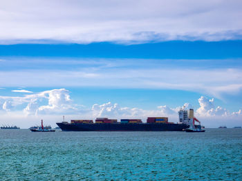 The tugs boat assisting cargo vessel to be berthing at indrustial port of thailand.