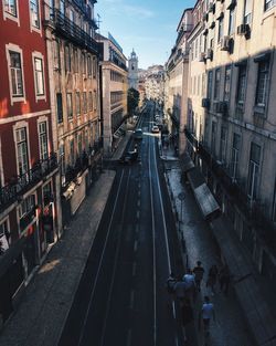 High angle view of people walking on road amidst buildings