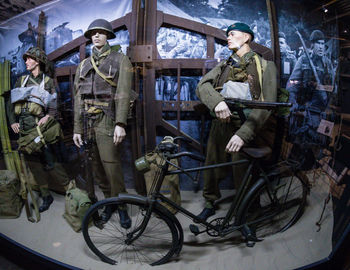 Man with bicycle standing in front of people