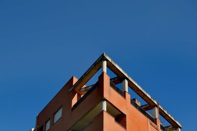 Low angle view of building against clear blue sky