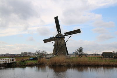 Traditional windmill against cloudy sky