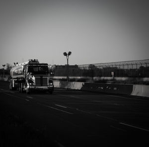 Train on street in city against clear sky