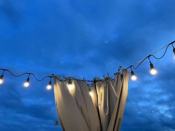 Low angle view of illuminated lamp against sky