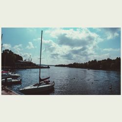 Sailboats moored in lake