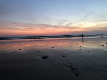 Scenic view of beach against sky during sunset