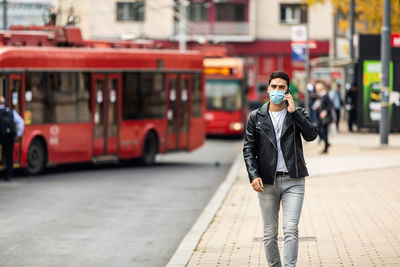 Portrait of man in a medical surgical mask in the summer city. coronavirus, illness, quarantine.