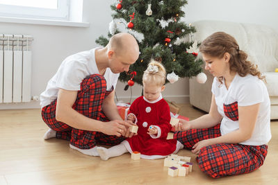 Couple with daughter at home during christmas