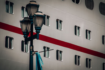 Low angle view of electric lamp by cruise ship