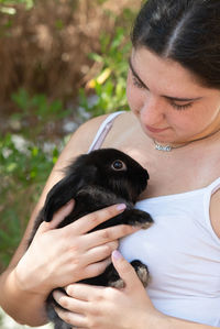 Midsection of woman holding hands outdoors