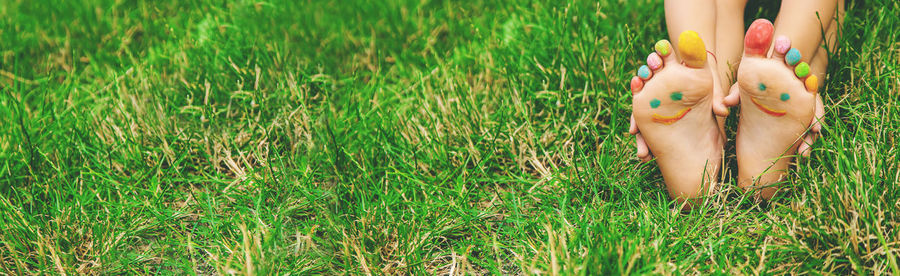 Low section of woman standing on grass