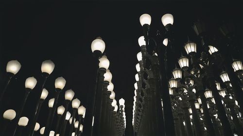 Low angle view of illuminated lamp at night