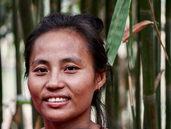 Close-up portrait of a smiling young tribal woman