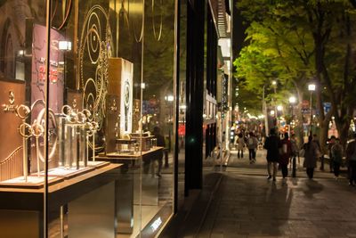 People standing on city street at night