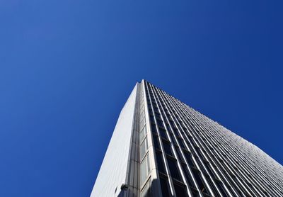 Low angle view of modern building against clear blue sky