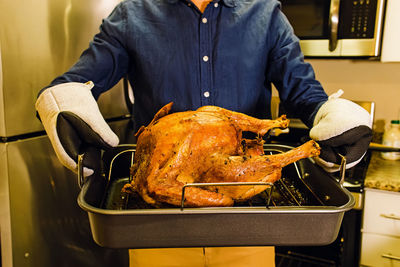 Midsection of man preparing food
