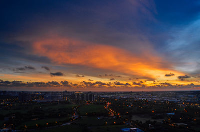 High angle view of illuminated buildings against sky during sunset