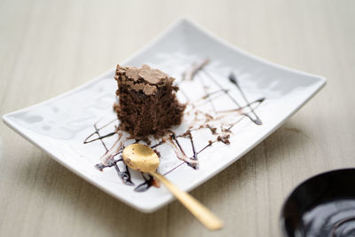 High angle view of chocolate cake in plate on table