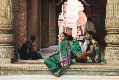 People sitting outside building