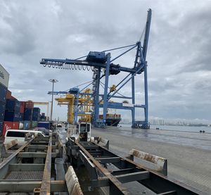 Cranes at construction site against sky