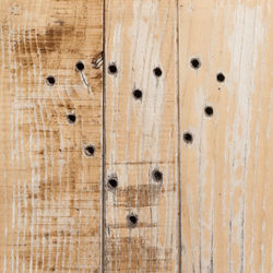 Holes forming heart shape on wooden door
