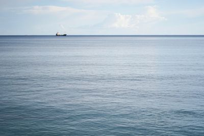 Sailboat sailing on sea against sky