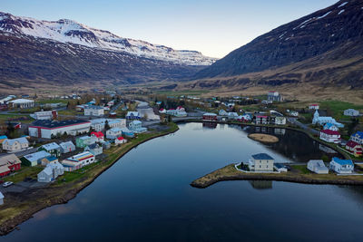 Scenic view of lake and buildings against sky