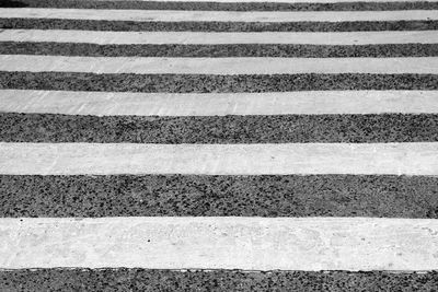 Detail shot of white lines on asphalt road