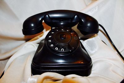 Close-up of telephone on table