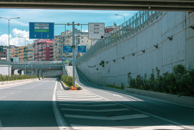 Road by city against sky