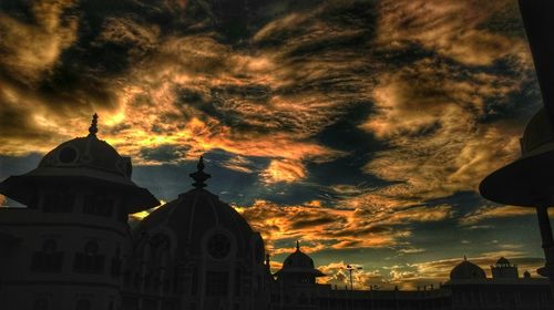 Low angle view of church against cloudy sky