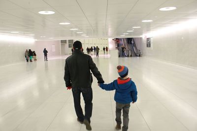 People walking in illuminated corridor