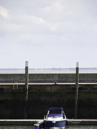 Car on bridge against sky