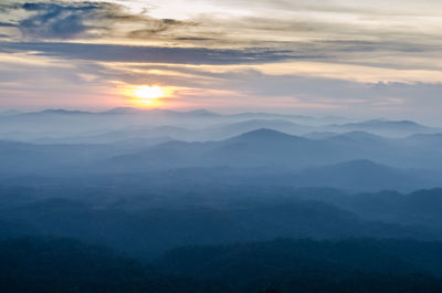 Scenic view of mountains against sky at sunset