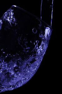 Close-up of water splashing against black background