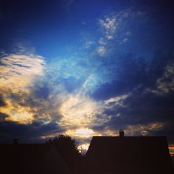 Low angle view of silhouette built structure against sky