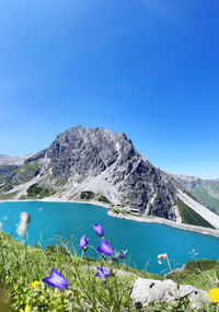 Scenic view of snowcapped mountains against clear blue sky