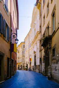 Empty street amidst buildings in city