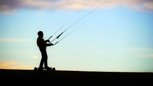 Silhouette of man against sky at sunset