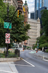 Road sign by city street