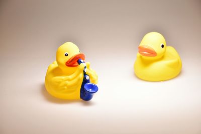 Close-up of yellow toy over white background